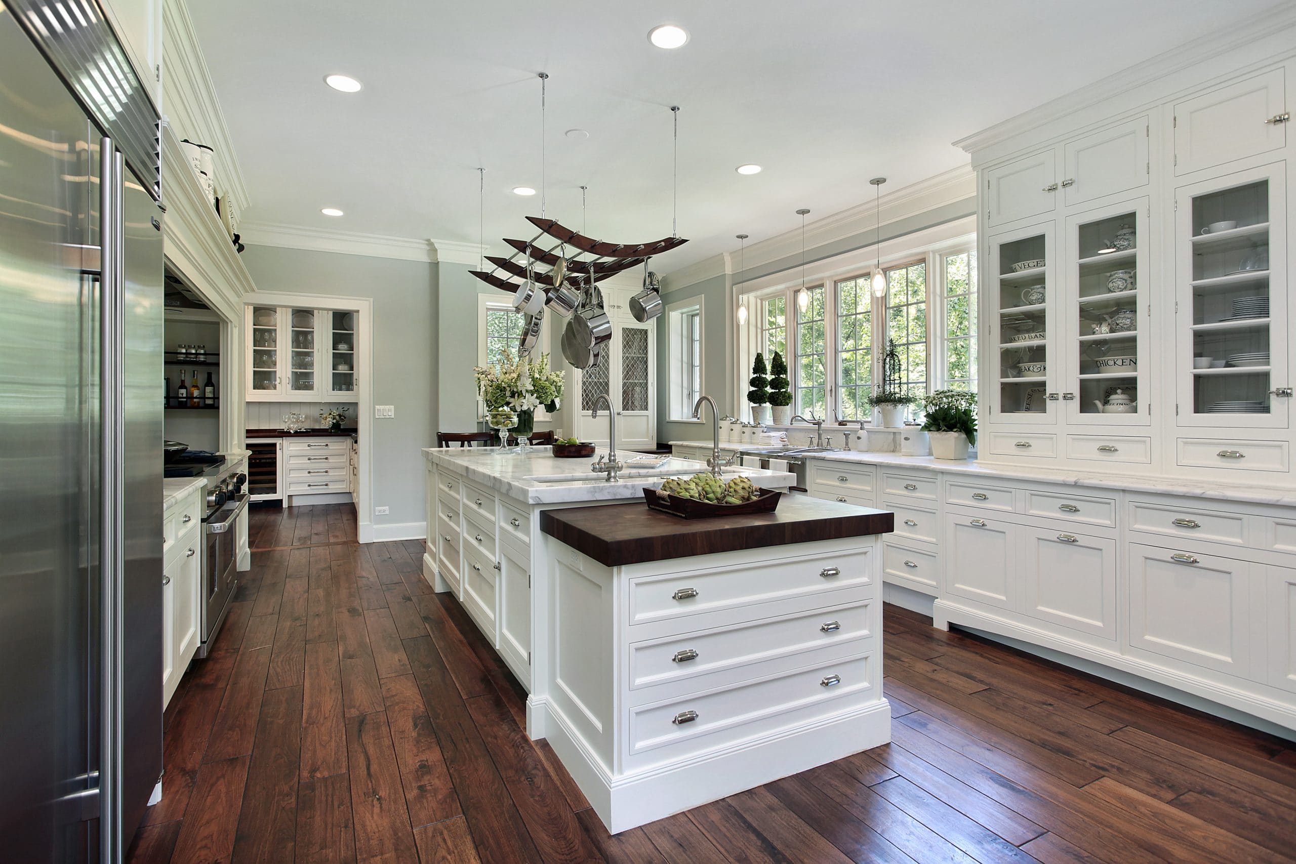 Kitchen in luxury home with white cabinetry