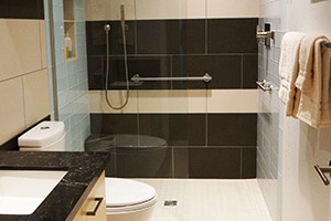 black and white bathroom tile with black granite countertop