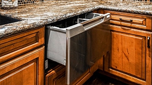 colonial maple colored counter with marbled countertop and dishwasher