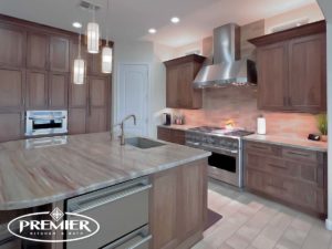 Luxurious kitchen remodel with rich wood cabinetry, marble countertops, and modern stainless steel appliances by Premier Kitchen & Bath