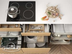 Modern kitchen setup by Premier Kitchen, featuring Pull-Out Cutlery Cubbies and organized storage solutions