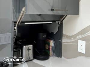 Appliance Garage with a lift-up cabinet door, housing a toaster and coffee maker