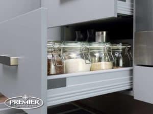 Pull-Out Spice Drawers by Premier Kitchen, featuring organized glass jars for efficient storage